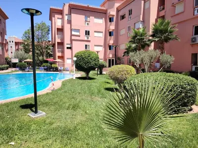 a resort with a swimming pool and buildings at Appartement de luxe Résidence Majorelle in Marrakech
