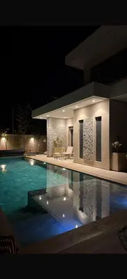 a swimming pool at night with a house at Villa coco in Marrakech