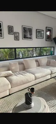 a living room with a couch with a hat on a table at Villa coco in Marrakech