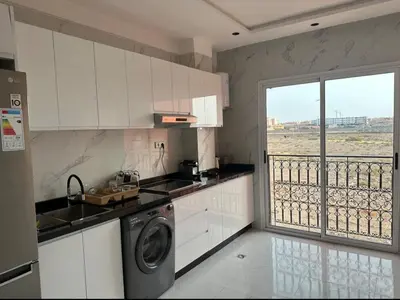 a kitchen with a washing machine and a balcony at Studio de luxe à Gueliz Marrakech in Marrakech