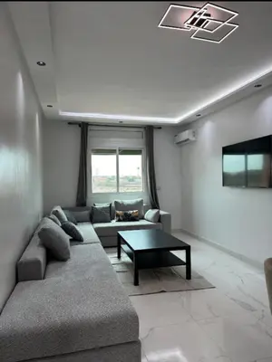 a living room with a couch and a coffee table at Studio de luxe à Gueliz Marrakech in Marrakech