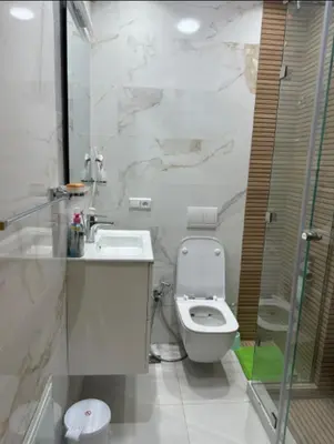 a white bathroom with a toilet and a sink at Studio de luxe à Gueliz Marrakech in Marrakech