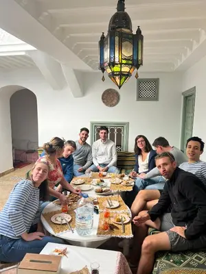 a group of people sitting around a table eating at Dar la famille Marrakech in Marrakech