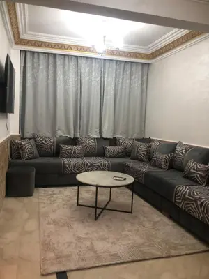 a living room with a couch and a table at Résidence Babylone Y - Appartement Studio in Marrakech