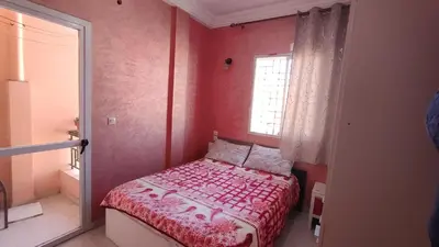 a small bedroom with a bed and a window at Saada 15 marrakech in Marrakech