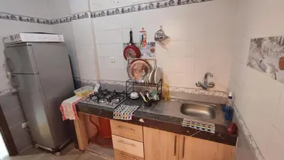 a small kitchen with a sink and a refrigerator at Saada 15 marrakech in Marrakech