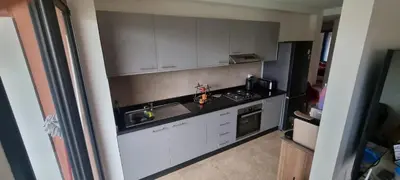 a kitchen with white cabinets and a sink at Appartement Domaine de Noria 7 in Marrakech
