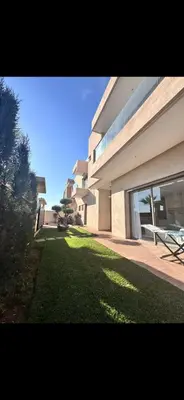 a large building with a lawn in front of it at Villa luxe kech in Marrakech