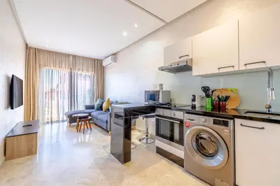 a kitchen with a washer and dryer in a room at Brand New and Stylish appart hotel Best location in Marrakech