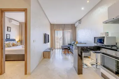 a room with a bed and a desk in a room at Brand New and Stylish appart hotel Best location in Marrakech