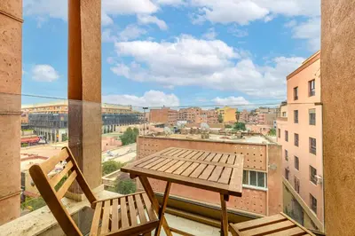 a table and chairs on a balcony with a view at Brand New and Stylish appart hotel Best location in Marrakech