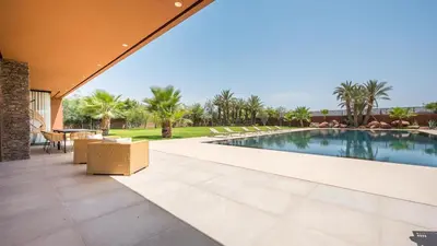 an external view of a swimming pool in a house at Villa Luxe Padel in Marrakech