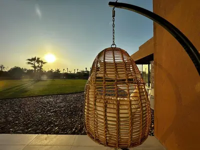 a wicker basket hanging from the side of a building at Villa Luxe Padel in Marrakech