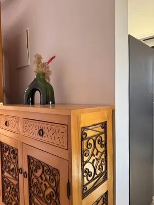 a wooden cabinet with a vase on top of it at Cosy Appartement Avec Piscine, Terrain tennis et loisirs in Marrakech