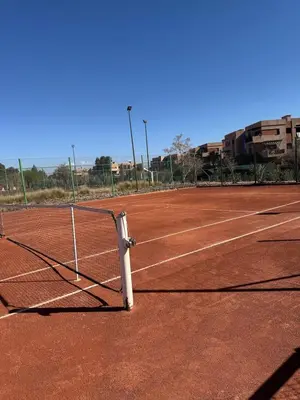 a tennis net on a tennis court at Cosy Appartement Avec Piscine, Terrain tennis et loisirs in Marrakech