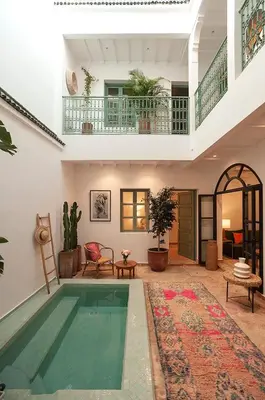 a house with a swimming pool in a living room at Riad Deva Lina in Marrakech