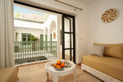a living room with a couch and a table with fruit on it at Riad Deva Lina in Marrakech