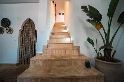 a stairway in a building with a potted plant at Riad Le Soleil de Bahia in Marrakech
