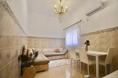 a living room with a couch and a table at Gold Holidays 02 in Marrakech
