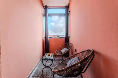 two chairs and a table in a room with a window at Charming Apartment in Hyper Center Modernity in Marrakech