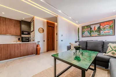 a living room with a couch and a table at Charming Apartment in Hyper Center Modernity in Marrakech