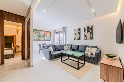 a living room with a couch and a table at Charming Apartment in Hyper Center Modernity in Marrakech