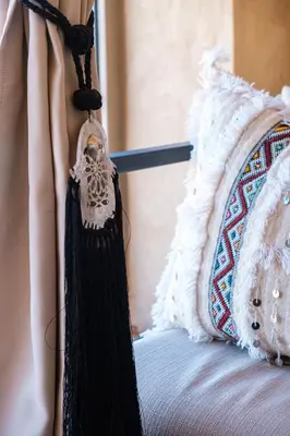a bed with a black and white blanket and a pillow at Coralia - Cozy Apartment - Secure residence - Pool in Marrakech