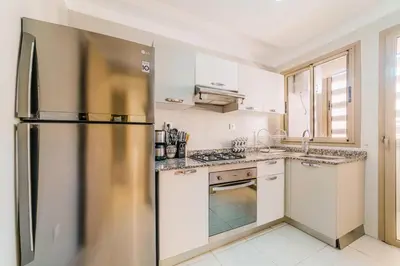 a kitchen with a stainless steel refrigerator at Coralia - Cozy Apartment - Secure residence - Pool in Marrakech