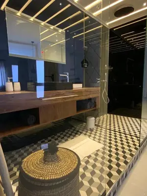 a bathroom with a sink and a counter with a table at Modern Place in Marrakech