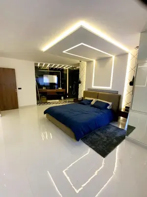 a bedroom with a blue bed in a white room at Modern Place in Marrakech