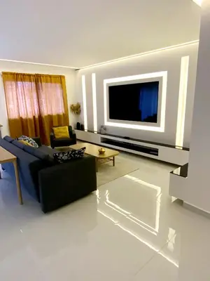 a living room with a couch and a tv at Modern Place in Marrakech