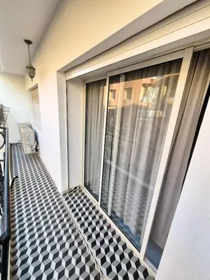 a balcony of a house with a large window at Modern Place in Marrakech