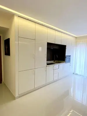 a living room with white cabinets and a flat screen tv at Modern Place in Marrakech