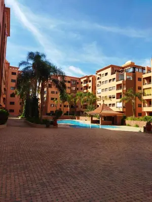 a courtyard with a swimming pool in a building at Résidence Babylone Y - 2 Bedrooms Appartement in Marrakech