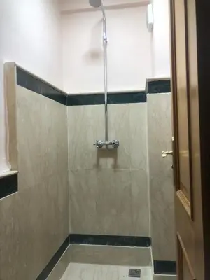 a shower with a glass door in a bathroom at Résidence Babylone Y - 2 Bedrooms Appartement in Marrakech