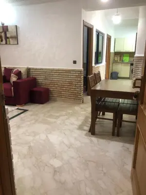 a living room with a table and a couch at Résidence Babylone Y - 2 Bedrooms Appartement in Marrakech