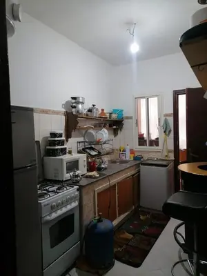 a kitchen with a stove and a microwave at Maison Mhamid9 in Marrakech