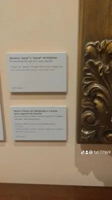 a plaque on a wall next to a piece of art at Al andalous in Marrakech