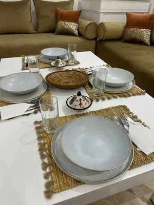 a table set with plates and utensils on a table at J40 super bien équipé a L'HIVERNAGE in Marrakech