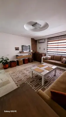a living room with a couch and a table at J40 super bien équipé a L'HIVERNAGE in Marrakech