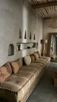 a room with a long couch with pillows on it at Riad en exclusivité Maison Habibi in Marrakech
