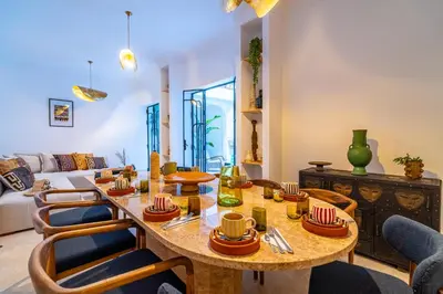 a living room with a table and chairs at Riad Sofia Marrakech in Marrakech