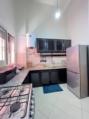 a kitchen with a stove and a refrigerator at charmant appartement Marrakech in Marrakech
