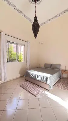 a bedroom with a bed and a window at charmant appartement Marrakech in Marrakech