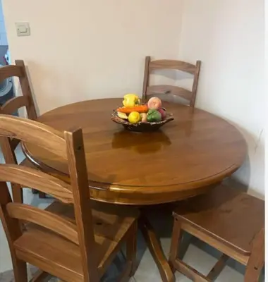 a wooden table with a bowl of fruit on it at Chambre privée dans un appartement bien équipé in Marrakech