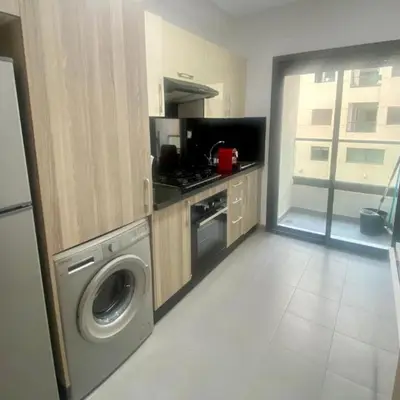 a kitchen with a washer and a washing machine at Chambre privée dans un appartement bien équipé in Marrakech