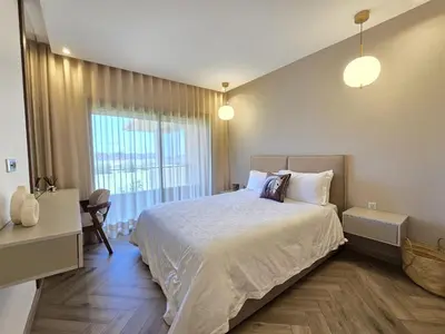 a bedroom with a large bed and a window at Sublime Apartment at Prestigia Golf, Marrakech in Marrakech
