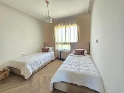 a bedroom with two beds and a window at Sublime Apartment at Prestigia Golf, Marrakech in Marrakech
