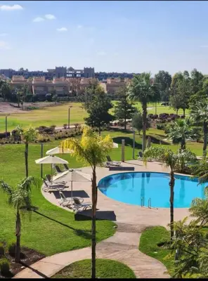 a view of the pool at the resort with palm trees at Sublime Apartment at Prestigia Golf, Marrakech in Marrakech