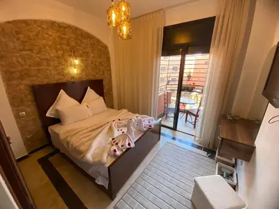 a bedroom with a bed with two dolls on it at Warda 2 Bedroom Hivernage Apartment in Marrakech